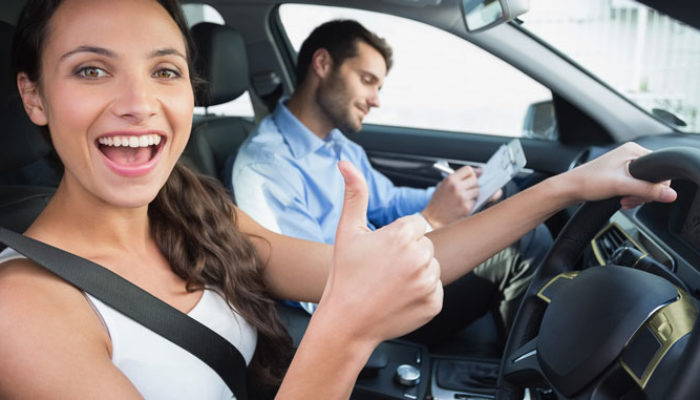 a girl is having fun on her driving lesson